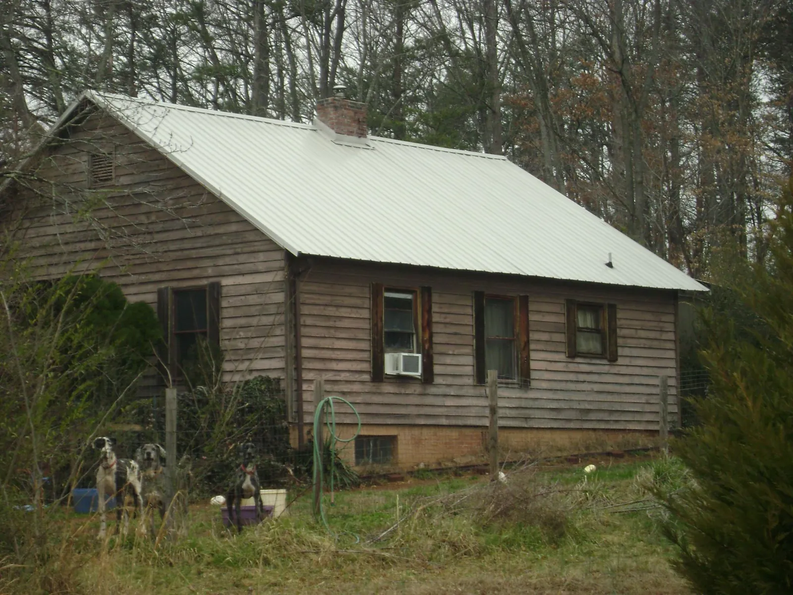 White metal roof on an old wood sided farmhouse, from a Metal Roof Installation job in Rutland